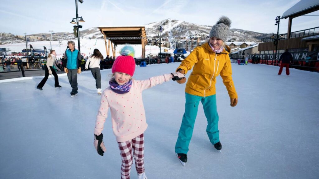 Mother and daughter ice skating on Skeeter's Ice Rink at Steamboat Resort.