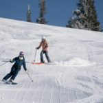 two teenage skiers